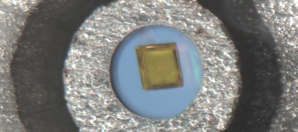View into a diamond anvil cell containing a single crystal of 4 4' bipyridinium hexachlororhenate(IV) in a 300 um gasket hole